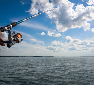 man hand with fishing rod and reel